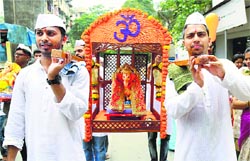 Devotees carry an idol of Lord Ganesha on the occasion of Ganesh Chaturthi, in Thane, Mumbai, on Friday. PTI 