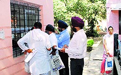 People queue up to pay property tax at a collection centre in Amritsar on Saturday