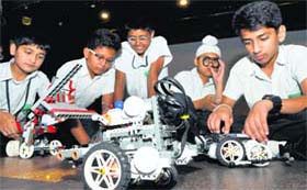 Tiny Techies: Students look at a robot during the regional tournament of the ninth edition of the Indian Robot Olympiad (IRO) at The Millennium School, Mohali, on Saturday