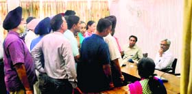 Principal Secretary, Local Government, Ashok Gupta gives a patient hearing to officials of the building branch at the Circuit House in Ludhiana on Saturday.