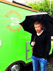 Freddie Flintoff poses in front of his mobile fish and chip van on Saturday. Flintoff is travelling across the United Kingdom in this van for a TV show.