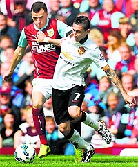Manchester Uniteds Angel di Maria (R) vies with Burnleys Dean Marney during their EPL match in Burnley on Saturday.