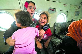 A woman and children in a military helicopter after being evacuated from Amerli, north of Baghdad.