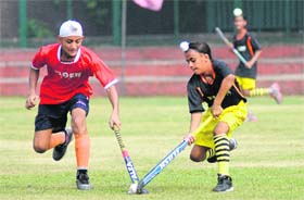Players of SGPC, Faridkot, and Surjeet Hockey Academy, Jalandhar, in action at the Sector 18 stadium in Chandigarh on Sunday