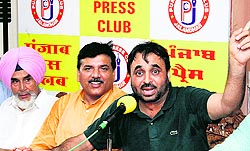 Sangrur MP Bhagwant Mann with AAP national spokesman Sanjay Singh and AAPs state convener Sucha Singh Chhotepur at a media conference in Jalandhar on Sunday