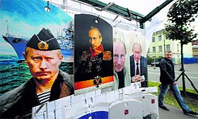 A man walks past cutting boards that have been painted with images of Russias President Vladimir Putin in St. Petersburg on Sunday.