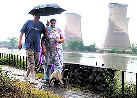 A couple enjoys a stroll along the Thermal Lake on a rainy day in Bathinda on Monday. 