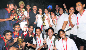 The boys team of Moti Ram Arya School and the girls team of Sacred Heart School in a jubilant mood after winning the State Ball Badminton Championship. 