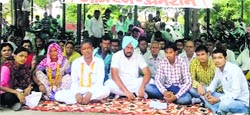 Amits family stages a dharna outside the Mini-Secretariat in Kurukshetra on Monday. Tribune photo