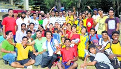 ADC Siddharth Acharya with participants of the Late Major Dhyan Chand District Hockey Tournament in Kullu on Sunday.