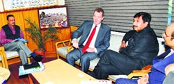 Industries Minister Mukesh Agnihotri interacts with UK Deputy High Commissioner David Lelliott in Shimla on Monday. A Tribune photograph