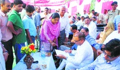 Excise and Taxation Minister Prakash Chaudhary listens to grievances of the public at Kansa Chowk in Mandi on Monday. Photo: Jai Kumar