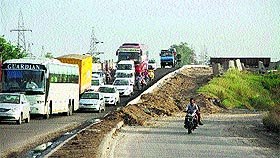 Traffic jam on one side of the Chugitti bridge that was again opened to traffic in Jalandhar on Monday. 