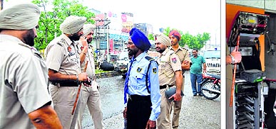 Police officials question a security man near the ATM at Haibowal in Ludhiana; and (right) the broken machine.