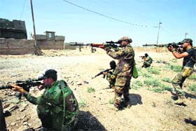 Shia militia fighters from the south of Iraq and Kurdish peshmerga forces take control of Sulaiman Pek from the Islamist State militants, in Tikrit city on Monday