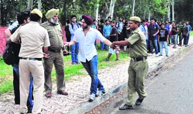 PU security officers round up students who had gathered on the university campus to leave for an amusement park on Tuesday
