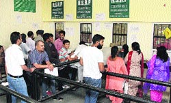 People queue up at the high security registration plate counters at the DTO in Jalandhar. Photo: Sarabjit Singh