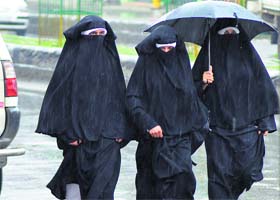 Umbrellas back: College students take a walk during rain at a town in Anantnag district of south Kashmir on Tuesday