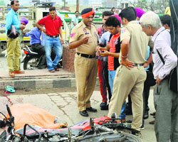 Police officials with a relative of the accident victim near Dholewal Chowk in Ludhiana.
