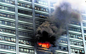 Smoke billows out of a window after the 24-floor iconic Chatterjee International Building caught fire in Kolkata on Tuesday morning. The fire is yet to be doused and 20 fire tenders have been rushed to the spot
