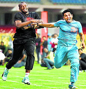 Bolt tries to pull back Yuvraj in a 100m dash;