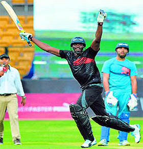 the Jamaican (r) celebrates after winning the four-over match in Bangalore on Tuesday.