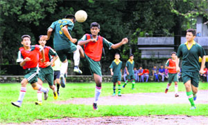 Players vie to take control of the ball during a match in the Colonel Shashi Memorial Football Tournament at Gorkha Military College in Dehradun on Tuesday
