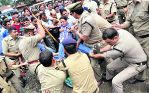 Policemen arrest unemployed BP Ed and MP Ed protesters at the Parade Ground in Dehradun on Tuesday.