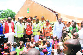 Refugees gather at a camp that was set up for Nigerians fleeing the violence, at Wurojuli.