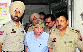 Police arrest the owner of Narang hospital, Dr Ashwani Narang (centre), in Amritsar on Wednesday.