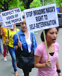 Activists of the Naga community hold placards as they participate in a protest march in New Delhi 0n Wednesday. 