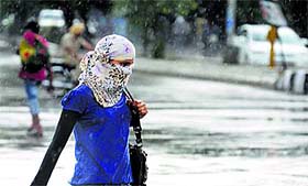 Commuters caught in the rain at Bhai Wala Chowk in Ludhiana on Wednesday.