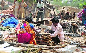 people collect their belongings after a demolition drive.