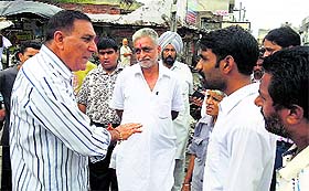 Members of the inquiry team from the Local Bodies Department argue with the complainant during the inspection of a road in Jagraon.