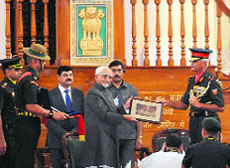 Vice-President Hamid Ansari being presented a memento at the Indian Military Academy in Dehradun on Wednesday.