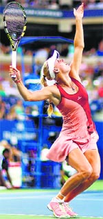 Caroline Wozniacki serves to Sara Errani during their quarterfinal; and Roger Federer celebrates after defeating Roberto Bautista Agut in Round 4 of the US Open in New York on Tuesday. AFP