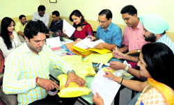Faculty members organise poll material on the eve of the elections at DAV College, Sector 10, in Chandigarh on Thursday. Tribune Photo: Pradeep Tewari