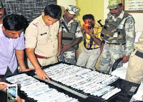 Policemen display gelatin packs and detonators recovered from the Majkhuwa bus station in Guwahati on Thursday