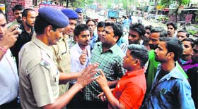 Angry relatives argue with police personnel in Dehradun on Thursday.