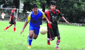 Players vie for the ball during a match in the Colonel Shashi Memorial Soccer Tournament at Gorkha Military School in Dehradun on Thursday.