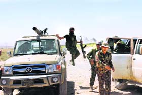 Fighters arrive at the front line during clashes with militants at Buyuk Yeniga village, Iraq, on Thursday