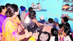 Students and teachers of Government Elementary School, Mahna Singh Road, watch the Prime Minister's speech in Amritsar on Friday. 