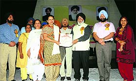 Education Minister Daljit Singh Cheema felicitates Mandeep Kaur, Principal, Government Girls Senior Secondary School, on Teachers Day function in Jalandhar on Friday.