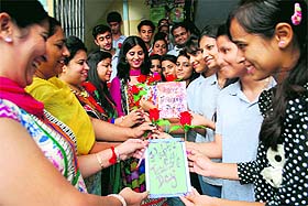 Students present roses and greeting cards to teachers at celebrations for Teachers Day at a school in Amritsar on Friday.
