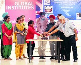 Faculty member at Teachers Day celebrations at Global Institutes; and (below) Teachers with mementoes presented at a function at Khalsa College of Education in Amritsar on Friday.