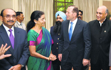Australian PM Tony Abbott with MoS for Finance Nirmala Sitharaman, CII president Ajay Shriram (L) and FICCI president Sidharth Birla (R) at a meeting in New Delhi on Friday.