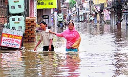 Residents wade through water in Paras Ram Nagar