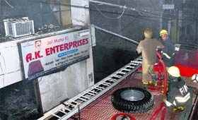 Firemen try to douse the flames at Maloya village in Chandigarh on Friday.