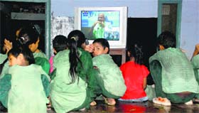 Children watch the PMs address sitting on a wet floor at a government school in Sector 17, Panchkula, on Friday.