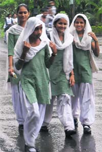 Students get drenched in rain while returning from school after the PMs address in Mohali on Friday.